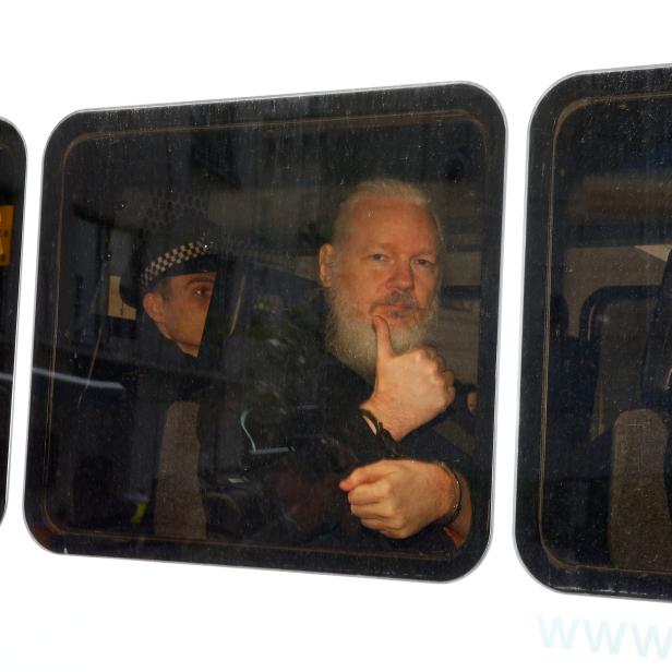 FILE PHOTO: WikiLeaks founder Julian Assange is seen in a police van after was arrested by British police outside the Ecuadorian embassy in London