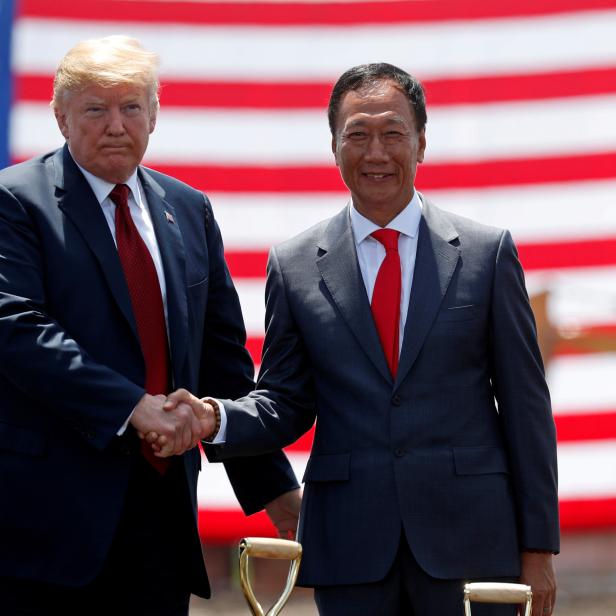 FILE PHOTO:  U.S. President Donald Trump shakes hands with Foxconn Chairman Terry Gou during a grond breaking at Foxconn's new site in Mount Pleasant