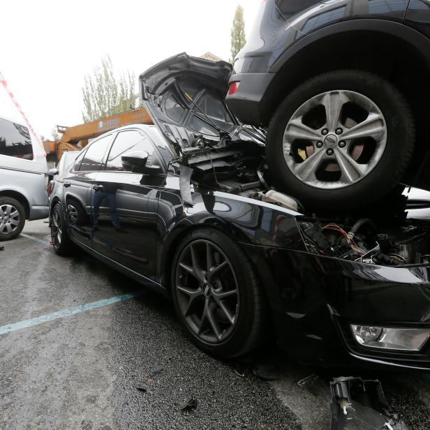 A man takes pictures at the site of a road traffic accident after a mobile crane crashed into passenger vehicles in Kiev