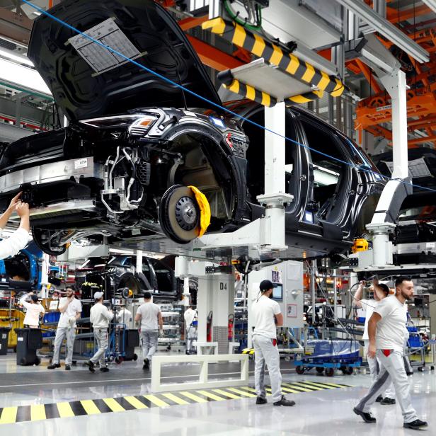 Workers are pictured at Audi e-tron cars production line of Brussels' assembly plant