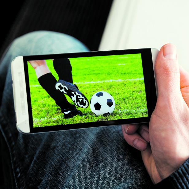 Watching a football match live streamed on mobile phone