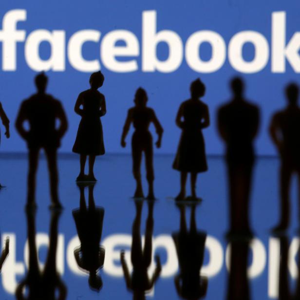 FILE PHOTO: Small toy figures are seen in front of Facebook logo in this illustration picture