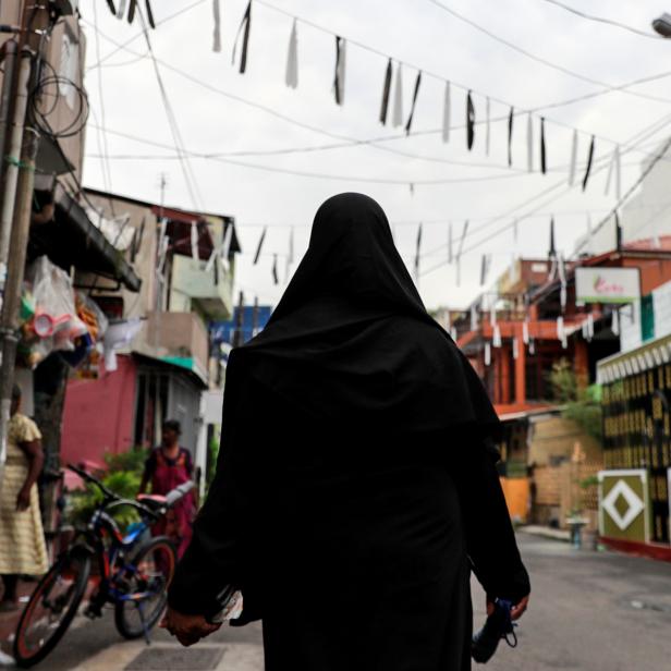 A Muslim woman wearing a hijab walks through a street near St Anthony's Shrine in Colombo