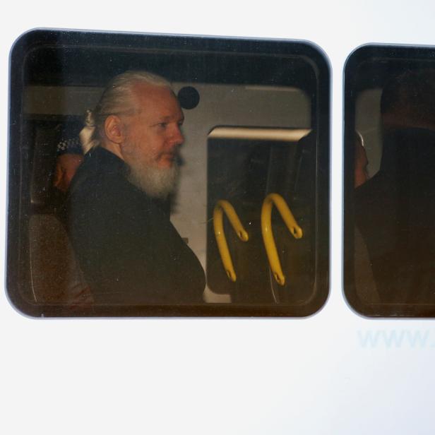 WikiLeaks founder Julian Assange is seen in a police van, after he was arrested by British police, in London