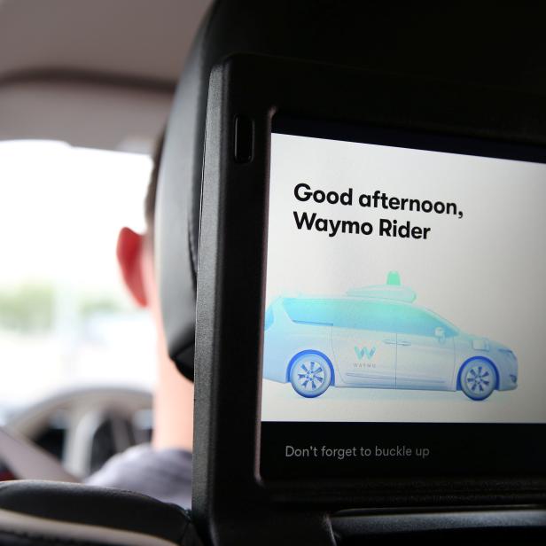 One of three screens displays the user interface inside a Waymo self-driving vehicle, during a demonstration in Chandler, Arizona