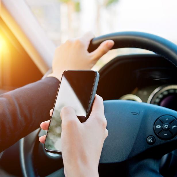 businesswoman texting while driving