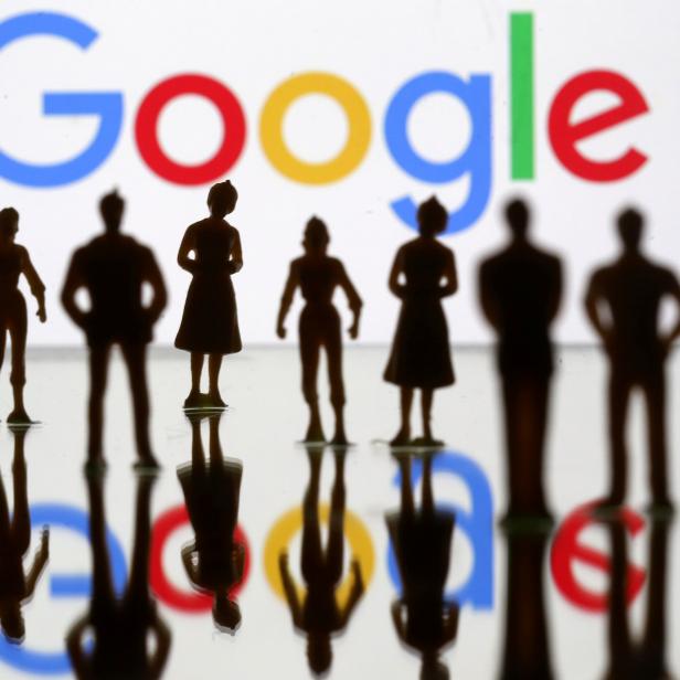 FILE PHOTO: Small toy figures are seen in front of Google logo in this illustration picture