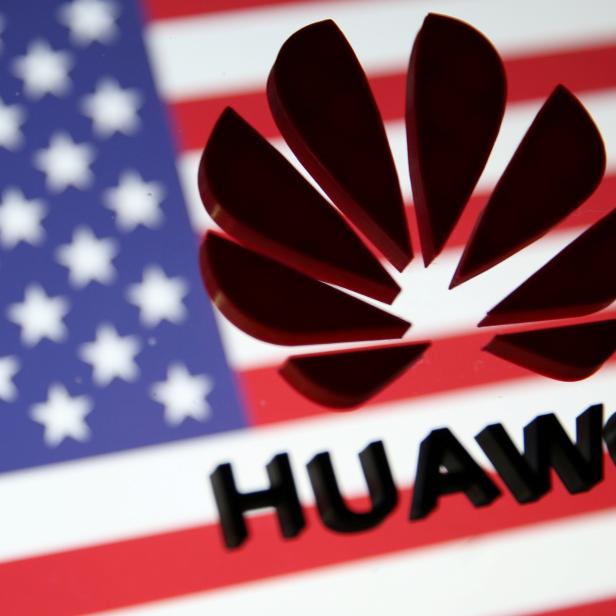 FILE PHOTO: A 3D printed Huawei logo is placed on glass above displayed U.S. flag in this illustration