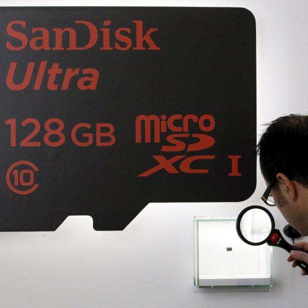 File photo of a visitor looking at a SanDisk microSD card at the Mobile World Congress in Barcelona