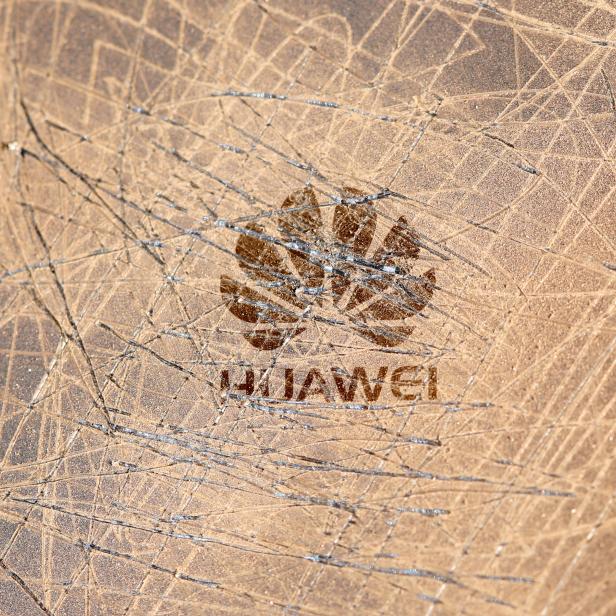 FILE PHOTO: A scratched surface Huawei logo is seen on a smarthphone in this illustration picture