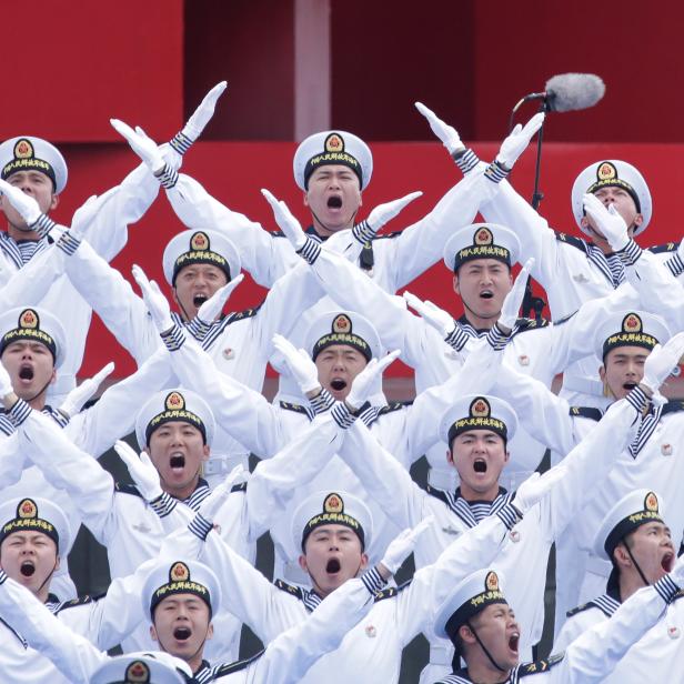 Chinese navy personnel perform at an event celebrating the 70th anniversary of the founding of the Chinese People's Liberation Army Navy (PLAN) in Qingdao