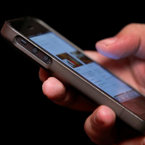 FILE PHOTO: A man uses a smartphone in New York City