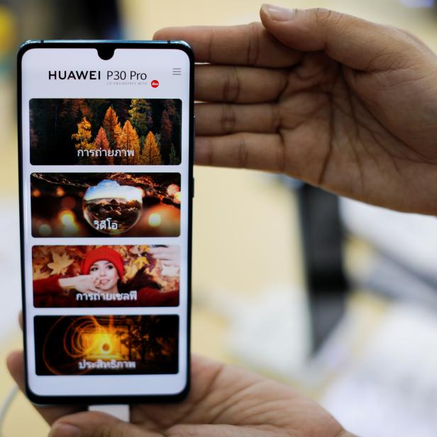 A vendor displays a Huawei P30 Pro mobile at the Mobile Expo in Bangkok