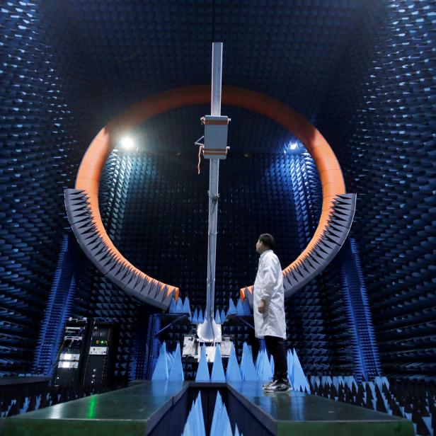 FILE PHOTO: An engineer stands under a base station antenna of 5G in Huawei's SG178 multi-probe spherical near-field testing system at its Songshan Lake Manufacturing Center in Dongguan