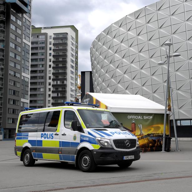 Police vans stand in front of the Friends Arena in Solna, outside Stockholm