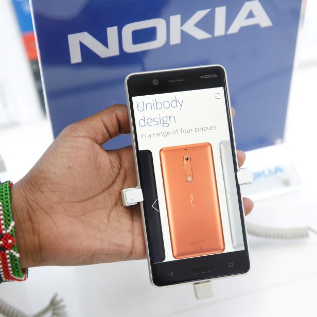 FILE PHOTO: A sales representative displays a Nokia 5 smartphone at a shop in Nairobi