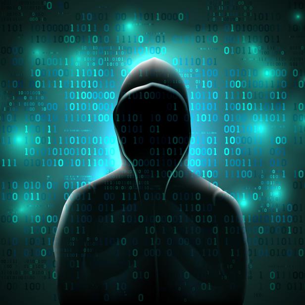 Silhouette of a hacker on a background with binary code and lights, hacking of a computer system, theft of data