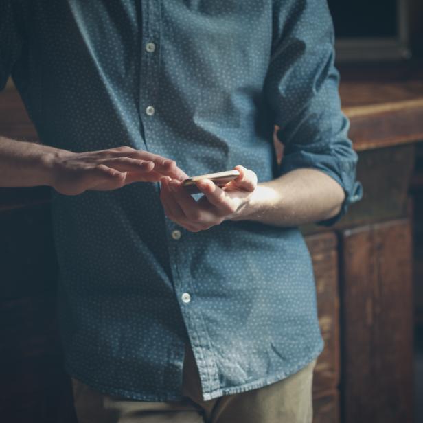 Young hipster using a mobile phone