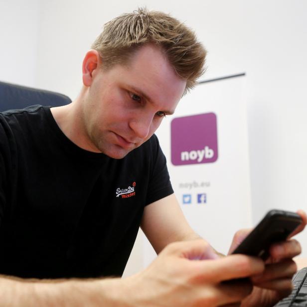 FILE PHOTO: Austrian lawyer and privacy activist Schrems checks his mobile phone in his office in Vienna