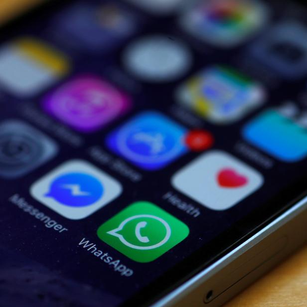 WhatsApp and Facebook messenger icons are seen on an iPhone in Manchester , Britain.