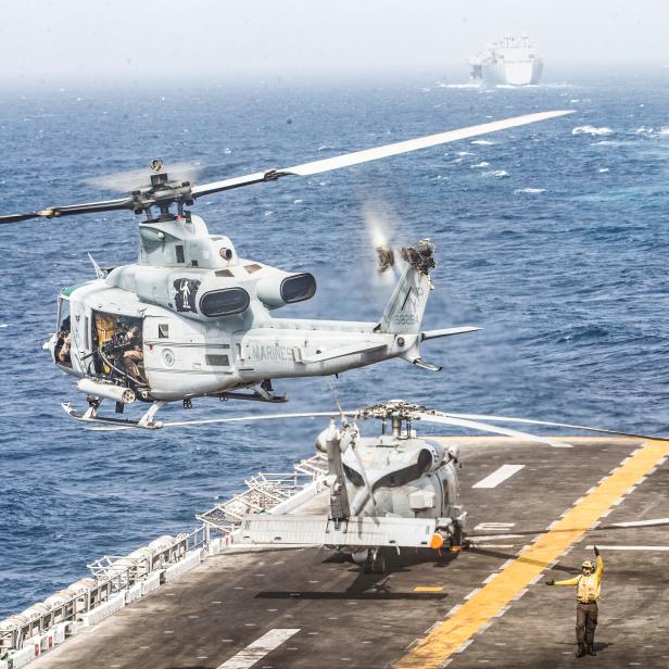 A UH-1Y Venom helicopter with Marine Medium Tiltrotor Squadron (VMM) 163 (Reinforced), 11th Marine Expeditionary Unit (MEU), takes off from the flight deck of the amphibious assault ship USS Boxer (LHD 4) during its transit through Strait of Hormuz