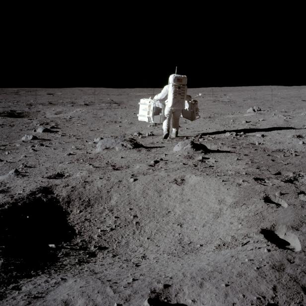 FILE PHOTO: Buzz Aldrin carries equipment for the Passive Seismic Experiments and Laser Ranging Retroreflector at Tranquility Base on the moon