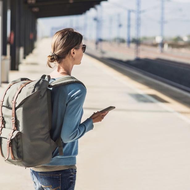 Young woman waiting for a train. Travel concept