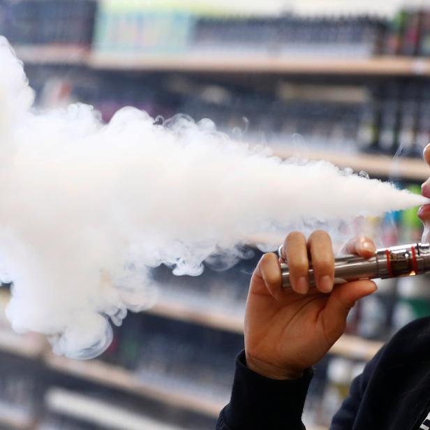 Patthasorn Kleespies of German e-cigarette manufacturer Eazzi tests a new vaping cigarette at the Eazzi headquarters in Gelnhausen