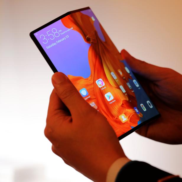 A member of Huawei staff shows the new Huawei Mate X device during a pre-briefing display ahead of the Mobile World Congress in Barcelona