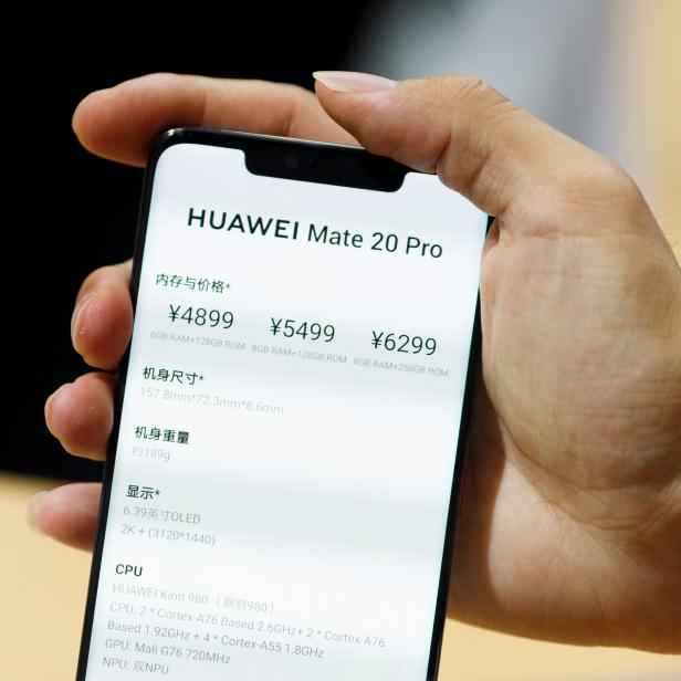 A man holds a Huawei Mate 20 Pro smartphone at the International Consumer Electronics Expo in Beijing