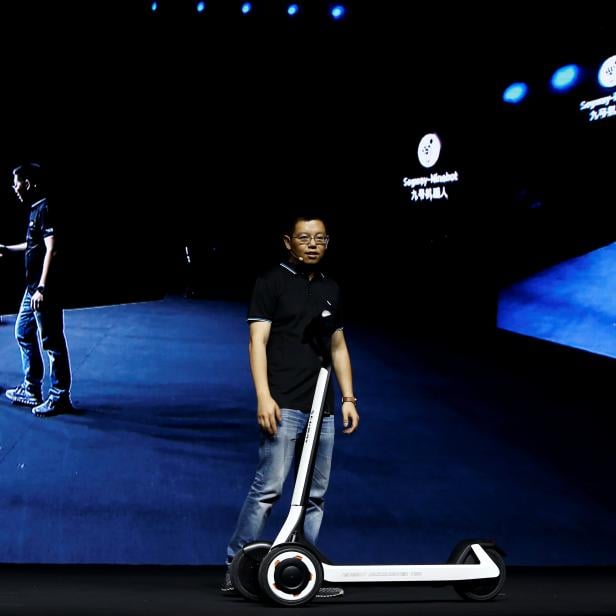 Ninebot President Wang Ye unveils semi-autonomous scooter KickScooter T60 that can return itself to charging stations without a driver, at a Segway-Ninebot product launch event in Beijing