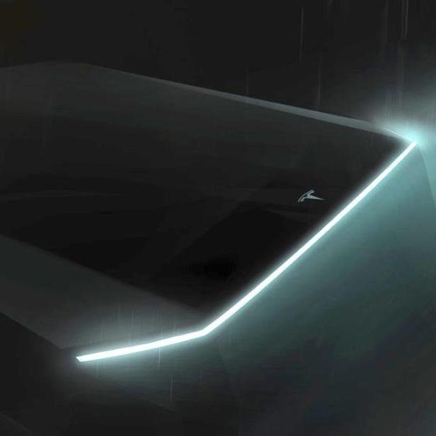 Ein futuristisches Tesla-Fahrzeug mit leuchtenden Akzenten im Dunkeln.