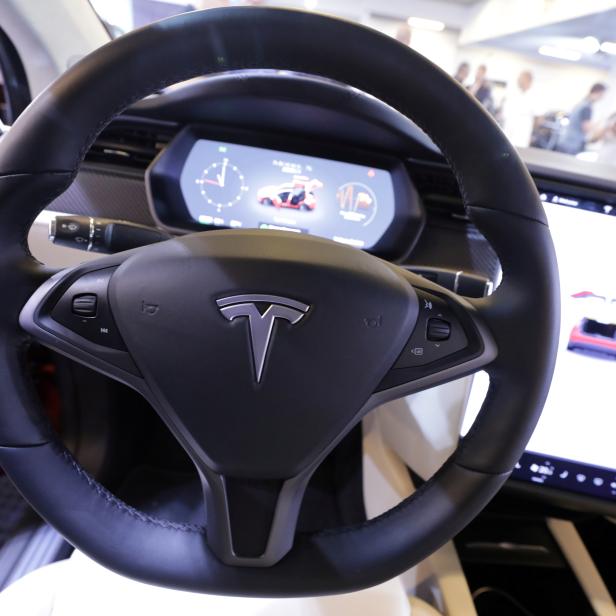 FILE PHOTO: The logo of Tesla carmaker is seen inside a car at the Top Marques fair in Monaco