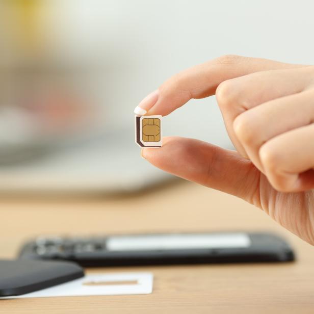 Woman hand holding a micro sim card