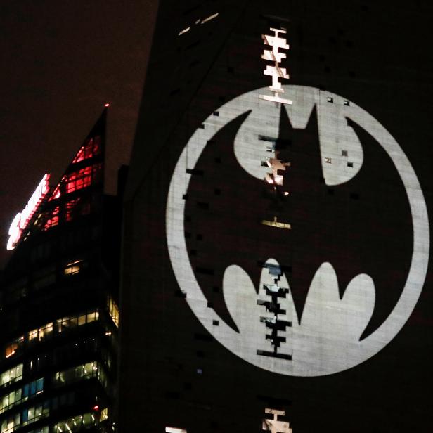 A Bat-Signal is projected onto a building at night as Batman fans celebrate the 80th anniversary of the first appearance of the DC Comics superhero, in Mexico City