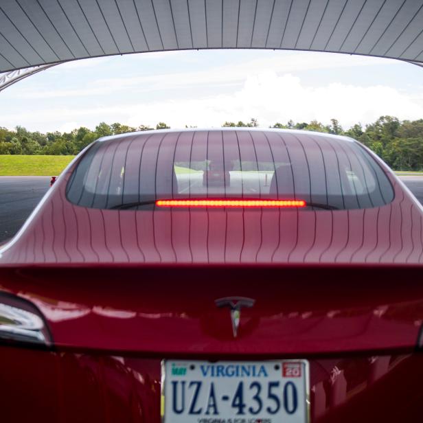 FILE PHOTO: IIHS media relations associate Young demonstrates a front crash prevention test on a Tesla Model 3 at IIHS-HLDI Vehicle Research Center in Ruckersville, Virginia
