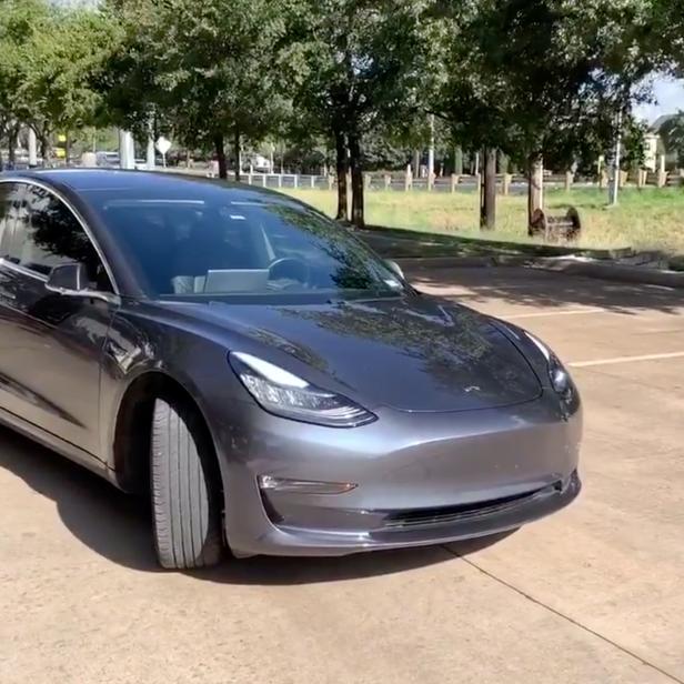 A Tesla 3 model is remotely driven with the company's phone app in Austin, Texas