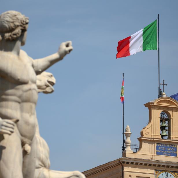 FILE PHOTO: The Italian flag waves over the Quirinal Palace in Rome