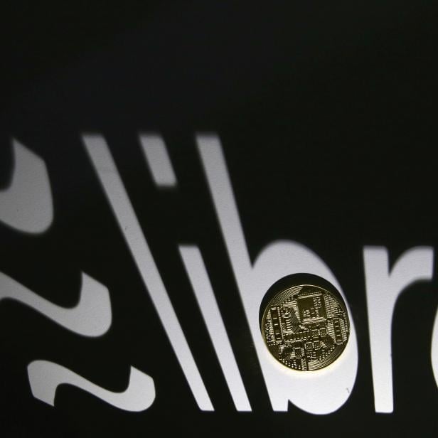 FILE PHOTO: FILE PHOTO: FILE PHOTO: Shadow of a 3D-printed Facebook Libra cryptocurrency logo is seen near cryptocurrency representation in this illustration taken