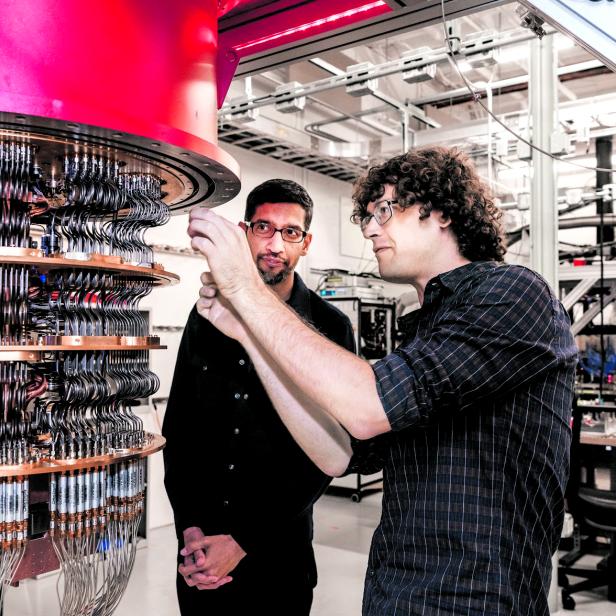 A handout picture shows Pichai and Sank with one of Google's Quantum Computers in the Santa Barbara lab