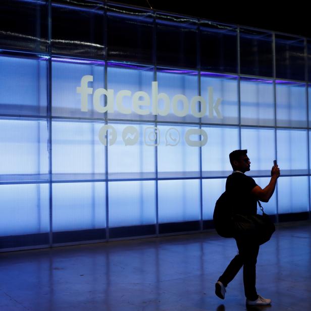 FILE PHOTO: An attendee takes a photograph of a sign during Facebook Inc's F8 developers conference in San Jose