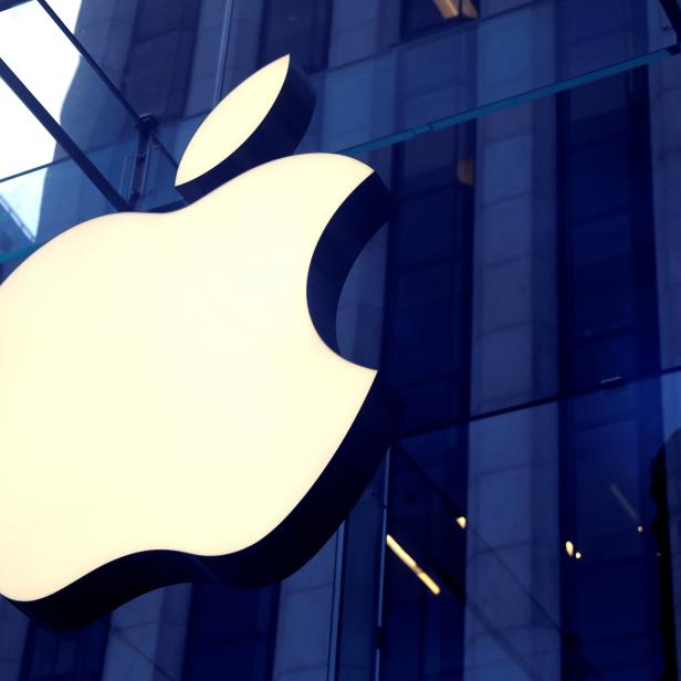 FILE PHOTO: The Apple Inc. logo is seen hanging at the entrance to the Apple store on 5th Avenue in New York