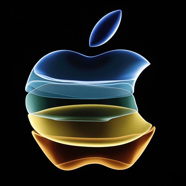 The Apple logo is displayed at an event at their headquarters in Cupertino