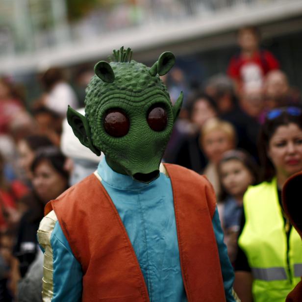 A member of the 501st Legion Spanish Garrison dress up as "Greedo" from the movie "Star Wars" during a solidarity parade to spread the message of bone marrow donation and the fight against cancer in Malaga 