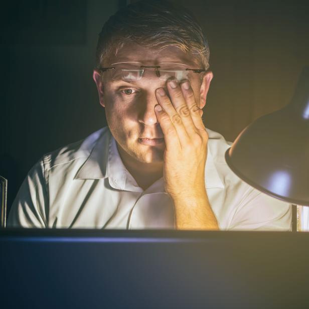 Man with tired eyes due to too much work on the computer screen