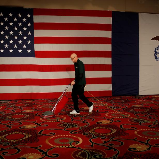 Worker Joe Robinson vacuums at the site of Democratic U.S. presidential candidate Senator Bernie Sanders' Caucus night rally in Des Moines