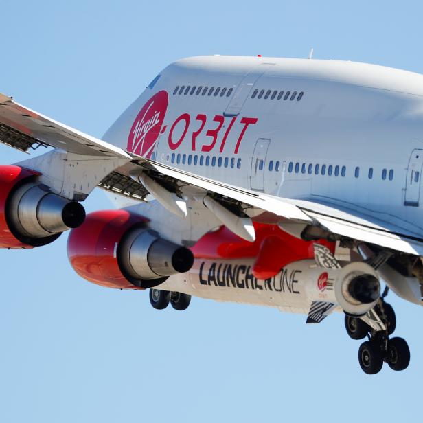 Richard Branson's Virgin Orbit, with a rocket underneath the wing of a modified Boeing 747 jetliner, takes off to for a key drop test of its high-altitude launch system for satellites from Mojave, California