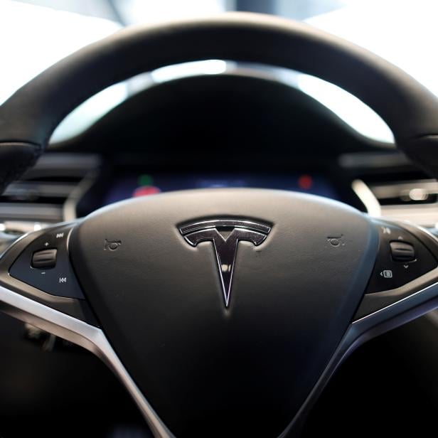 FILE PHOTO: The logo of Tesla is seen on a steering wheel of its Model S electric car at its dealership in Seoul