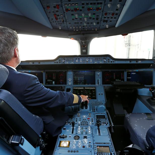 A pilot poses in a cockpit of a Lufthansa Airbus A350-900 after the baptism of the 10th Lufthansa A350 to the name "Erfurt", at Munich airport