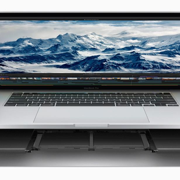 Ein geöffneter MacBook Pro mit einem Foto von schneebedeckten Bergen auf dem Bildschirm.